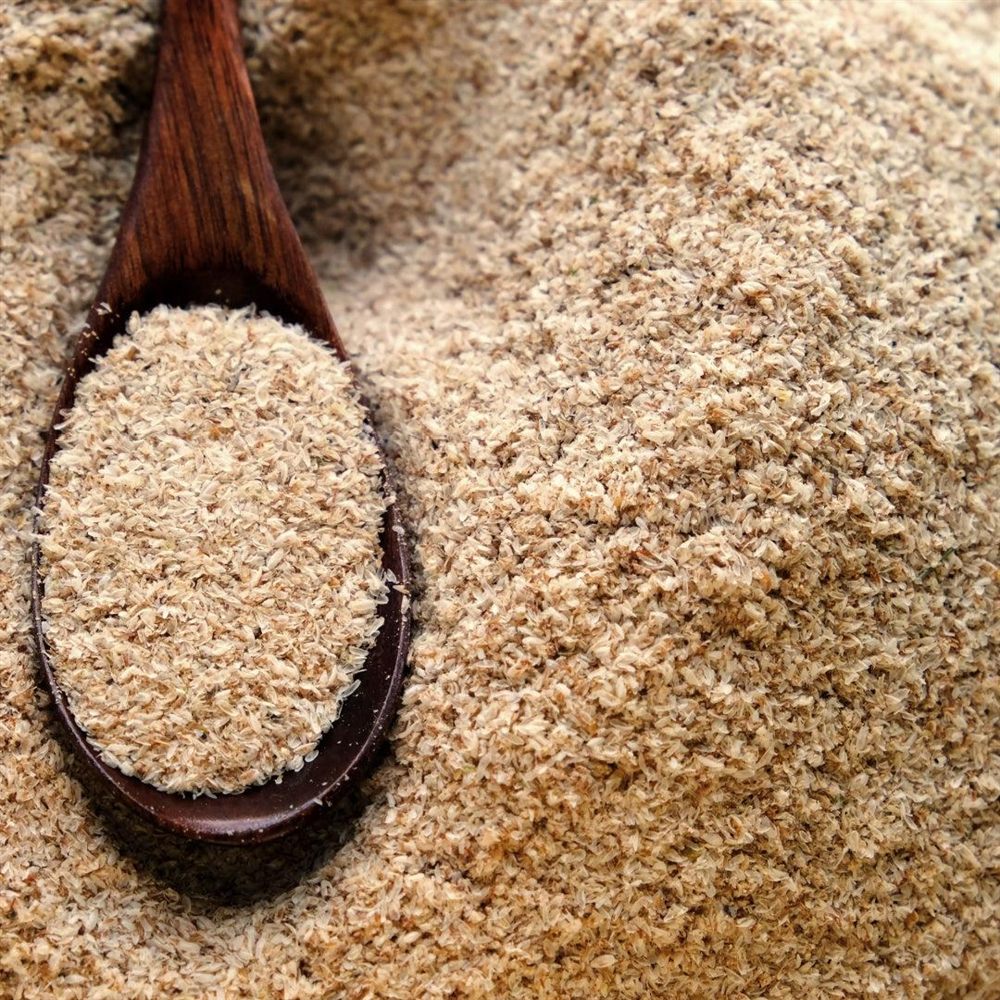 Coarse wheat bran in a wooden spoon